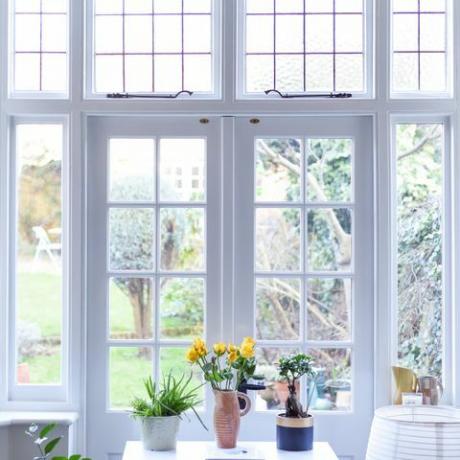 interior elegante do quarto com portas francesas e cores neutras claras em uma casa moderna
