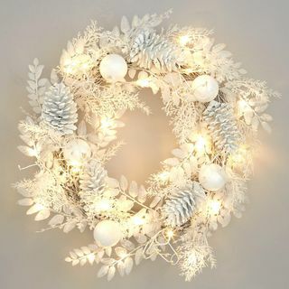 Coroa de flores de inverno branco pré-iluminada