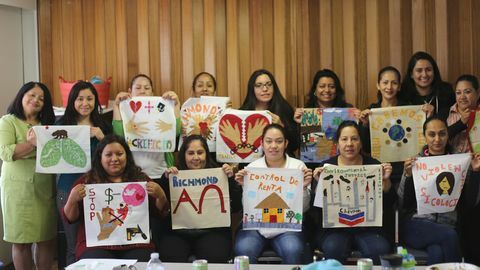 duas filas de participantes do workshop sjsa segurando quadrados de colcha que criaram