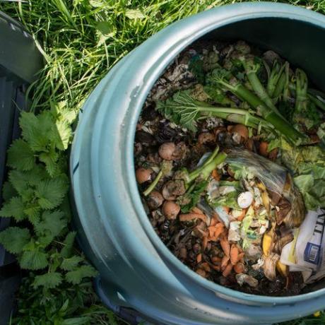 Vista superior da caixa de compostagem doméstica com restos de cozinha e outros materiais orgânicos